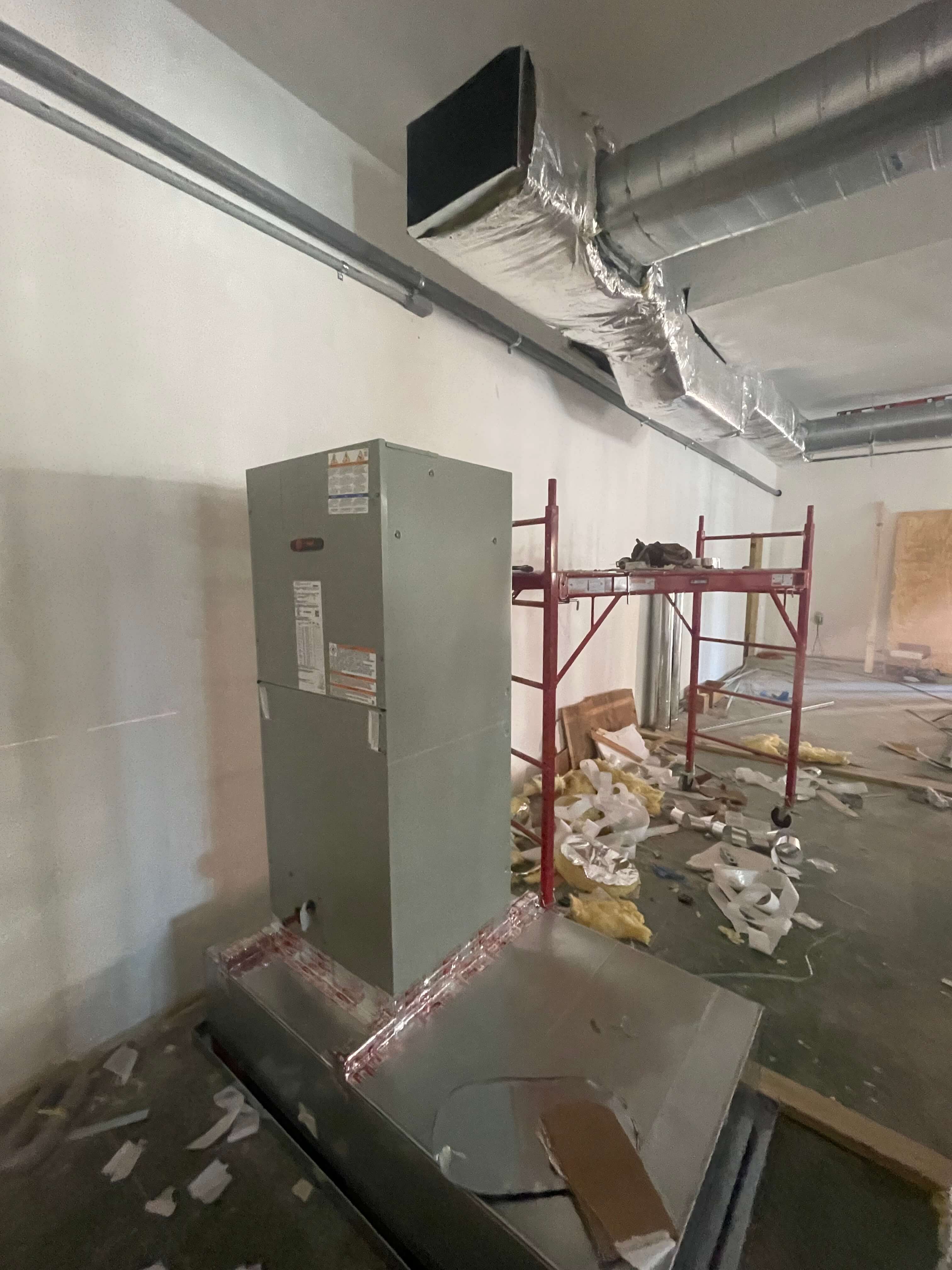Vertical air handler and overhead ductwork